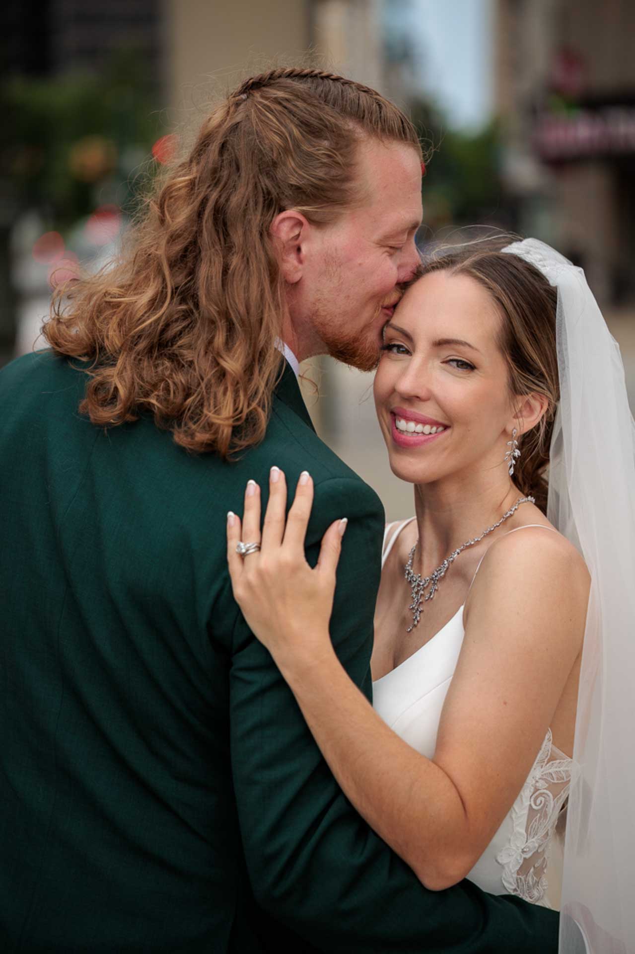 Groom kissing bride at their Downtown Detroit, Michigan Wedding Photo by Olga Gamburg Experiential Photographer