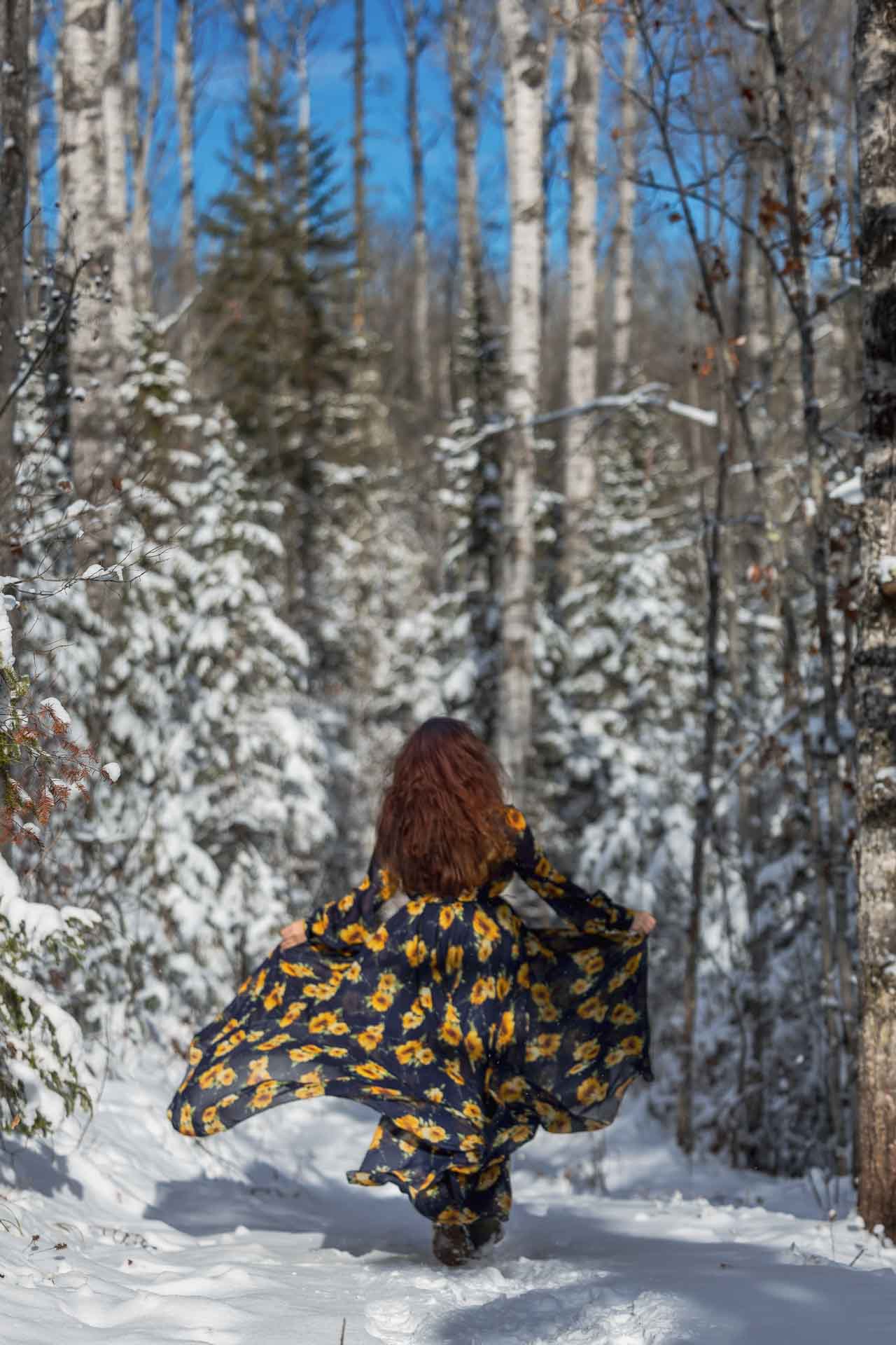 Olga Gamburg running through the snowy woods in Houghton-Douglass Falls in Calumet Township, Michigan