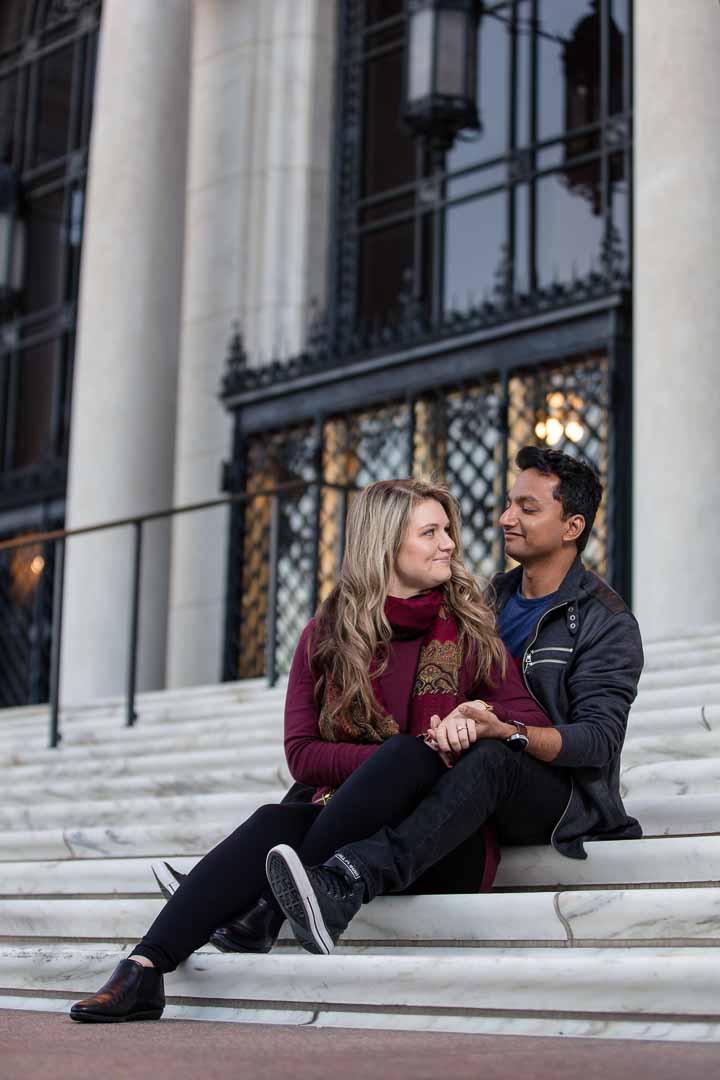 Engagement Photo Session of Couple sitting on marble stairs at Detroit Institute of Arts Michigan by Olga Gamburg Wedding Photographer