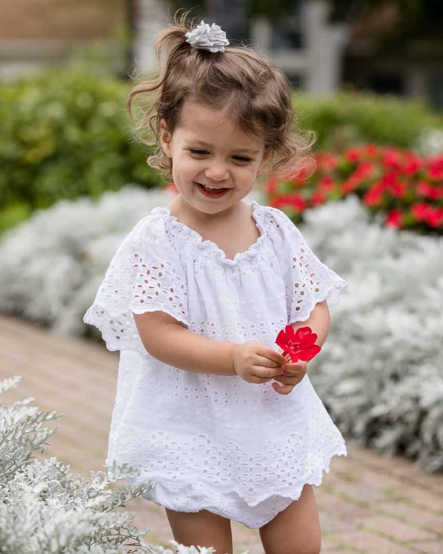 Family Portraits of Kid Toddler Girl with red flower in Birmingham, Michigan by Olga Gamburg Photography